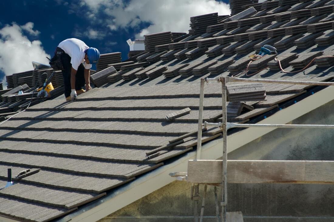 Roofers installing a roof over battens